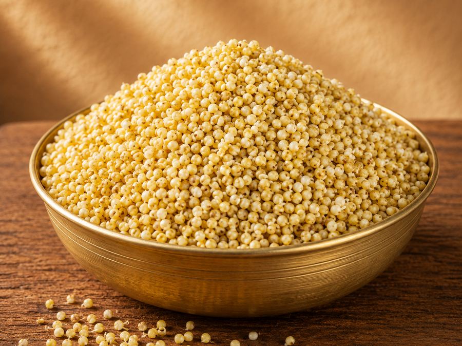 Parboiled millet grains in a brass bowl