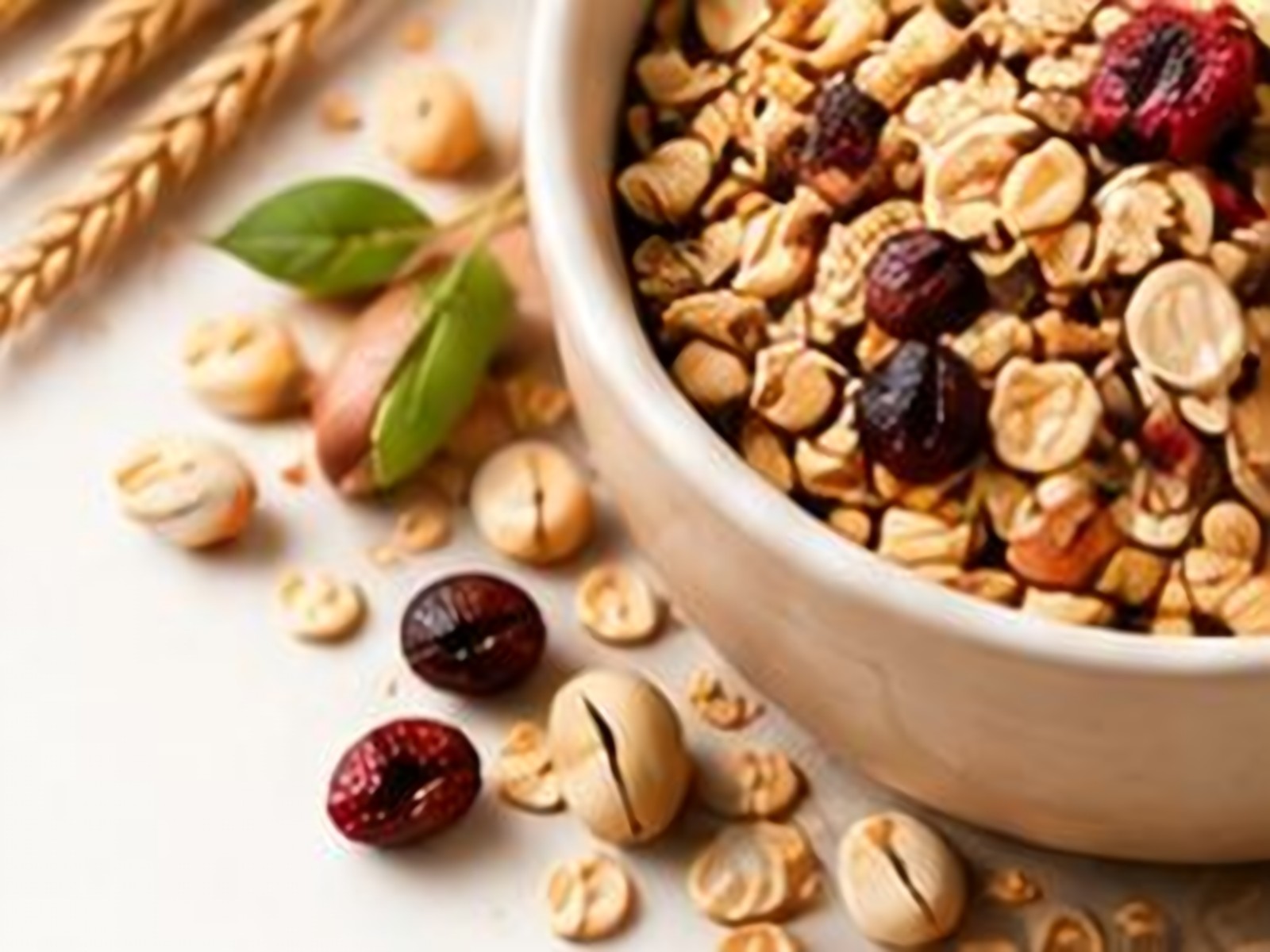 Bowl of whole grains and millets with wheat stalks